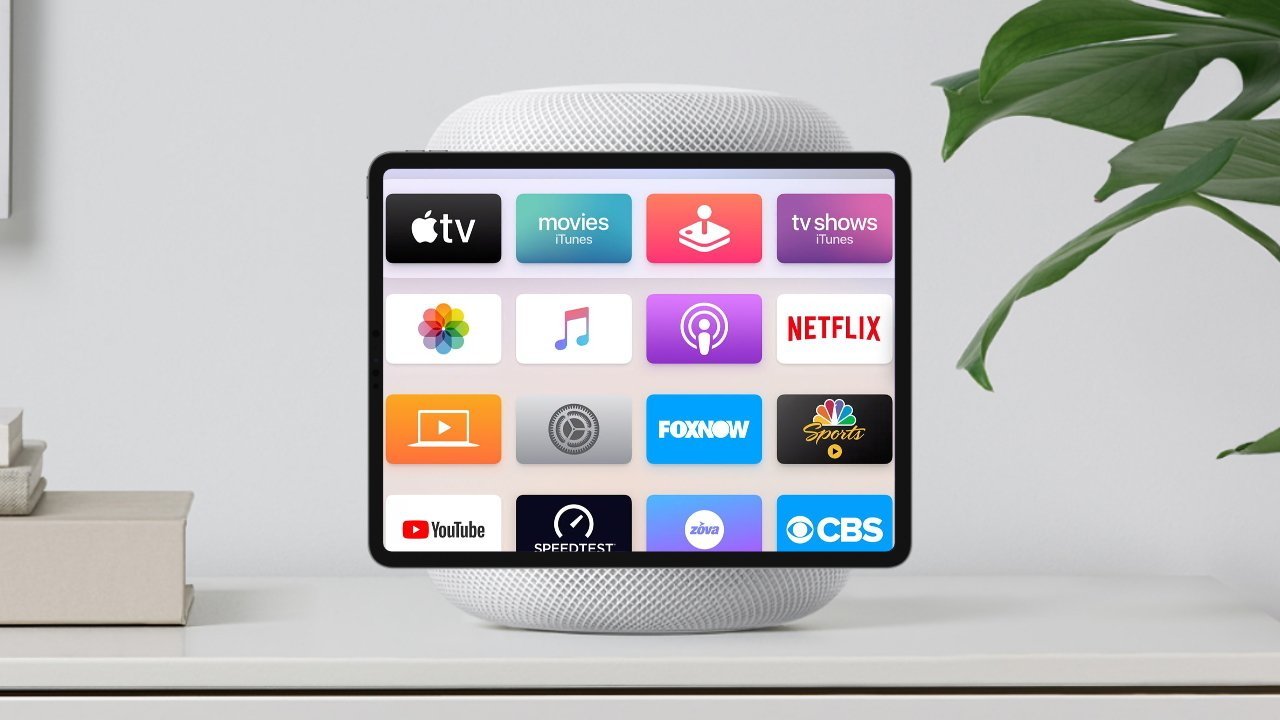 Планшет с иконками потоковых приложений, включая Apple TV, Netflix, YouTube и другие, установлен на смарт-колонке рядом с растением на белой поверхности.